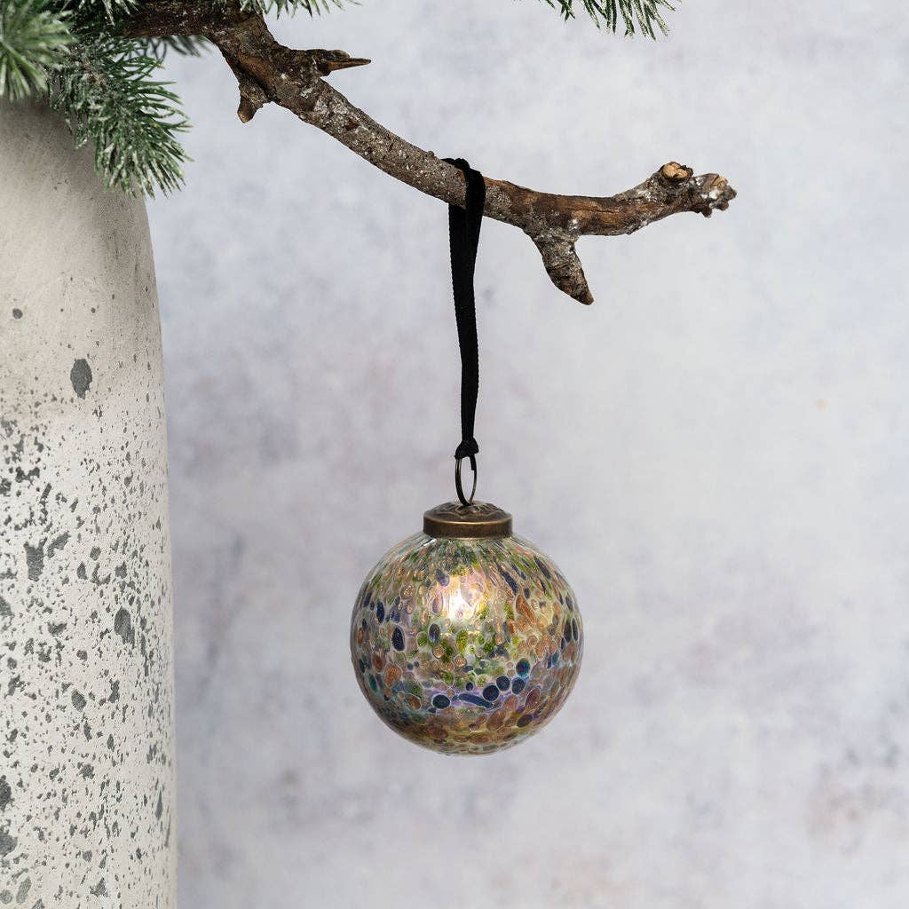 Close-up of melted glass chips on a handmade Christmas bauble