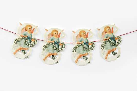 Die-cut Victorian-style cherub carrying a flower garland