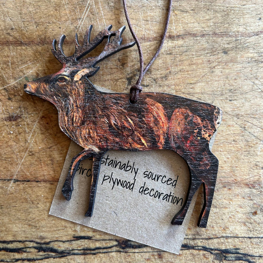 Wooden eco deer decoration with a tag on a wooden surface