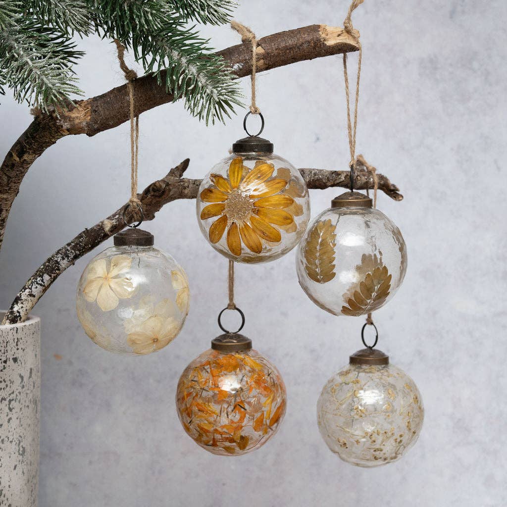 Detail of zinnia flowers set within a handmade glass bauble