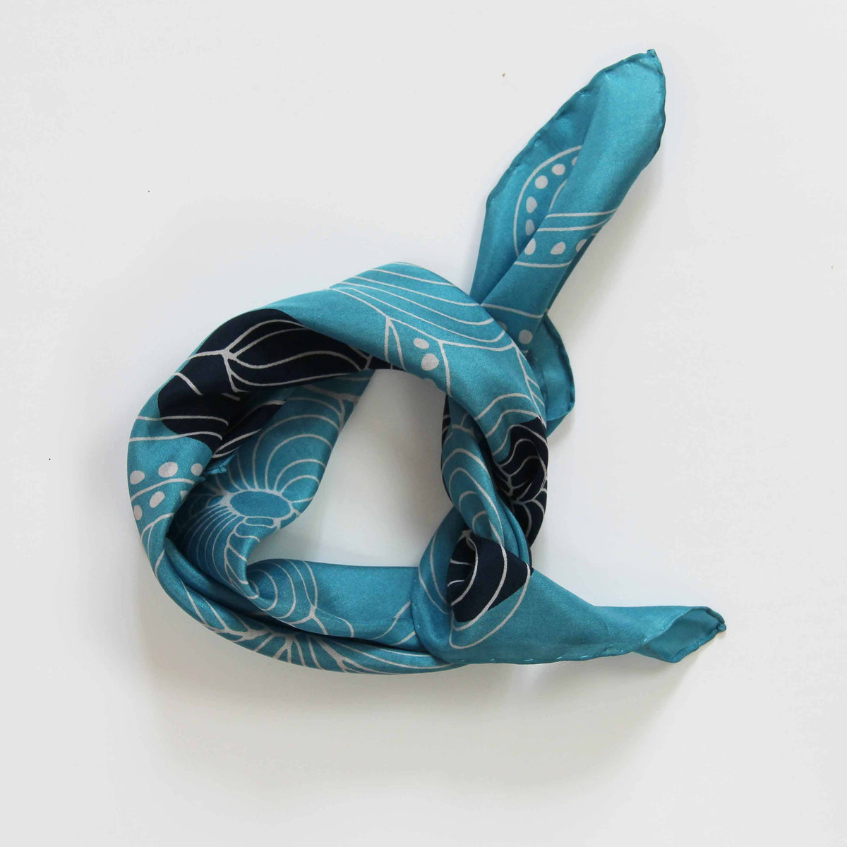Turquoise scarf with black and white patterns