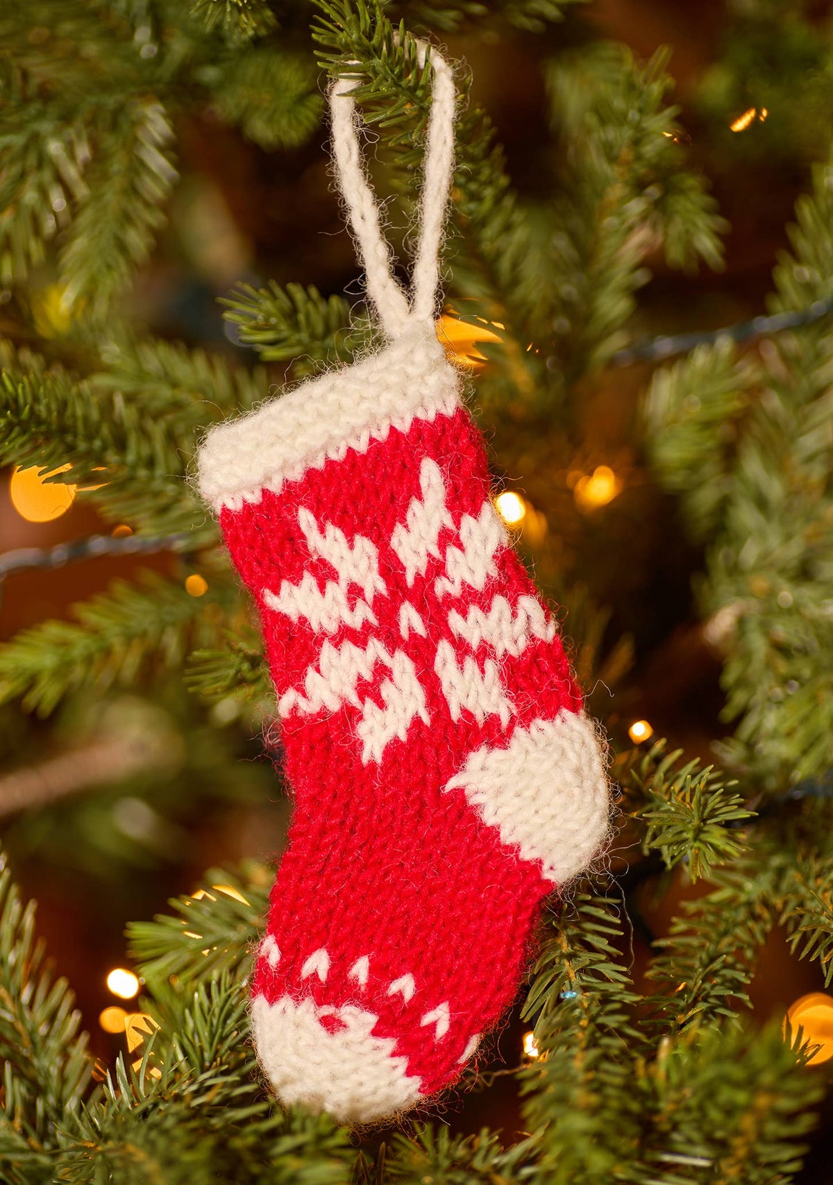 Knitted stocking tree decoration with striped cuff and hanging loop