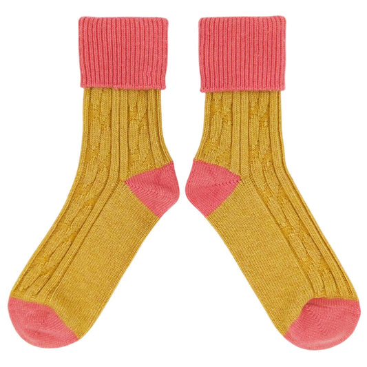 Pair of yellow cashmere socks with coral pink cuffs and toes
