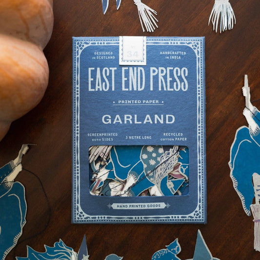 Witches Garland by East End Press on a wooden surface with pumpkin
