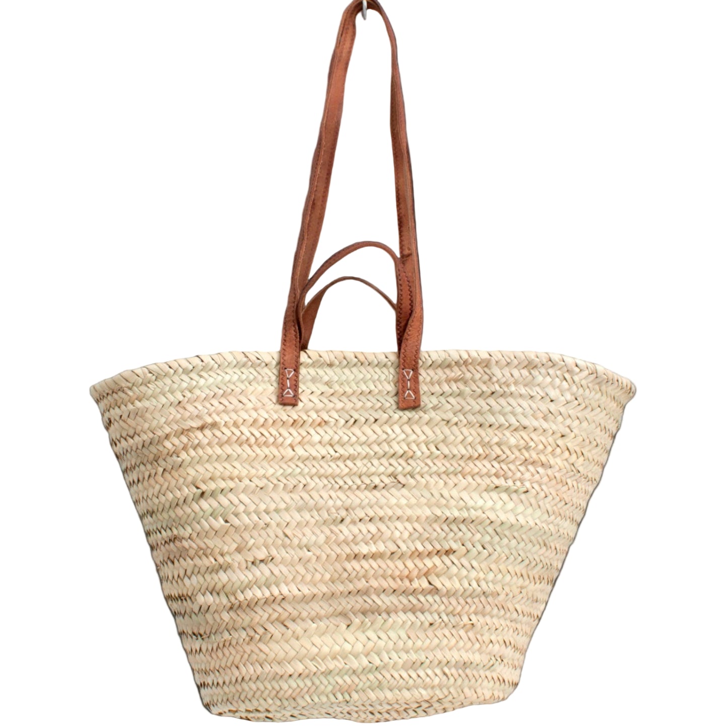 A market basket made of palm leaf with brown leather handles