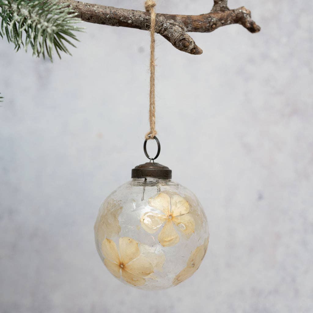 Floral botanical glass bauble with off-white flowers on a jute hanger
