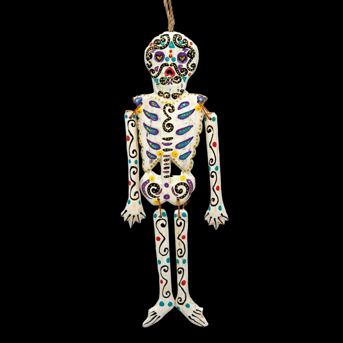Small candy skull skeleton hanging from a tied twine loop