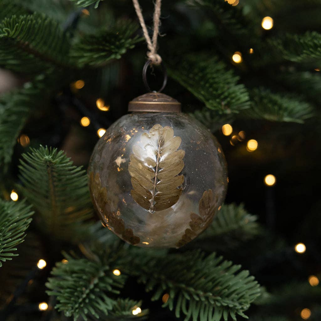 Detail of foliage within a handmade clear glass bauble