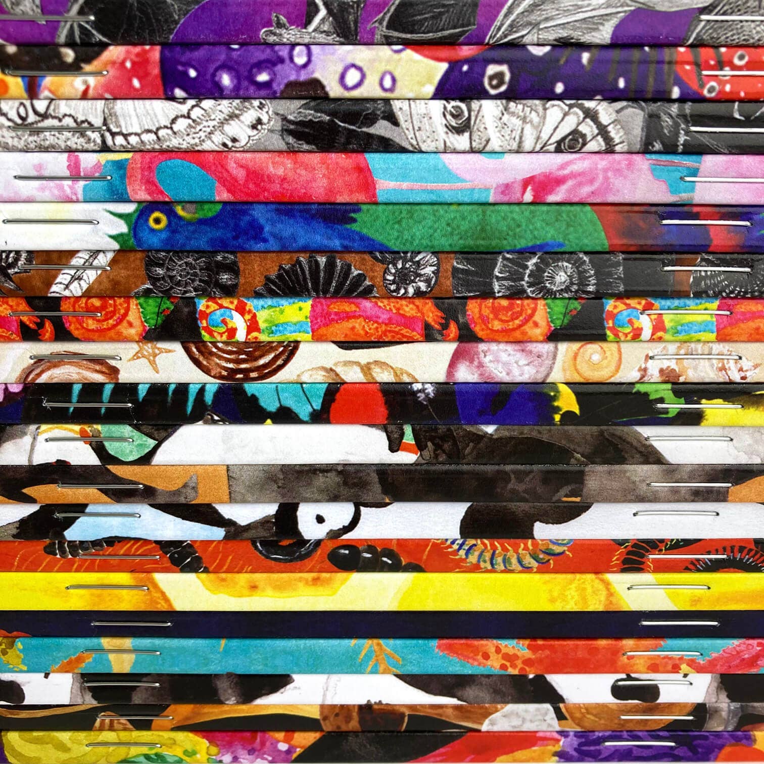 various hand painted notebooks in a stack