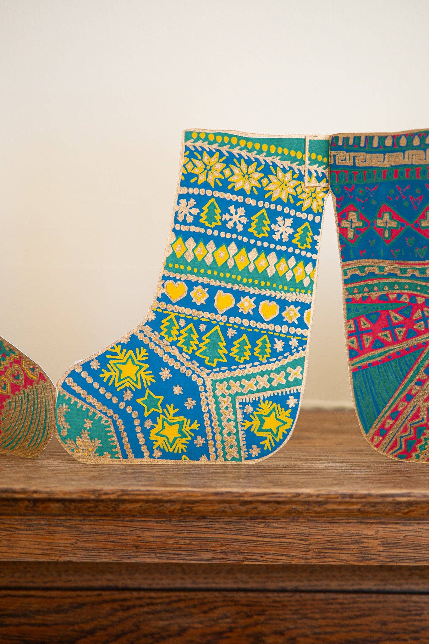 Colorful patterned socks decoration on a wooden surface with a neutral background