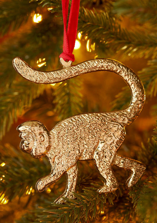 Monkey Christmas decoration in gold-tone recycled aluminium on a red velvet hanger