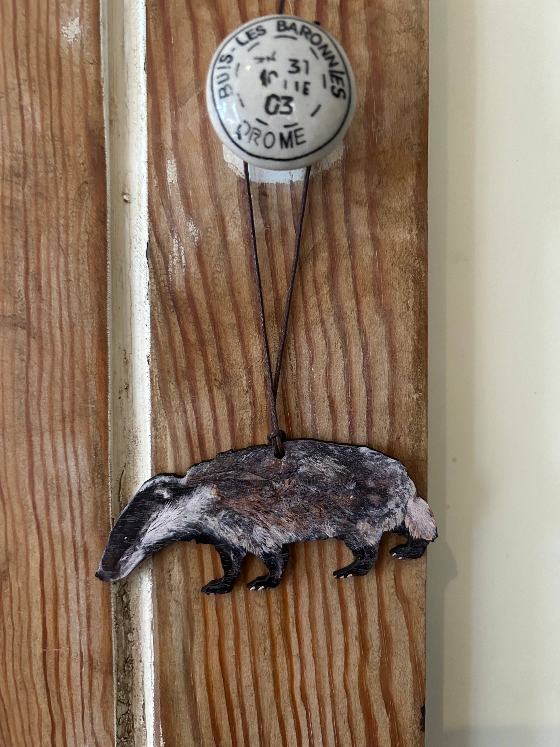 eco woodland badger seasonal decoration hanging on door knob