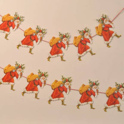A decorative garland featuring repeated die-cut and embossed motifs of Father Christmas carrying a Christmas tree and sack of presents.