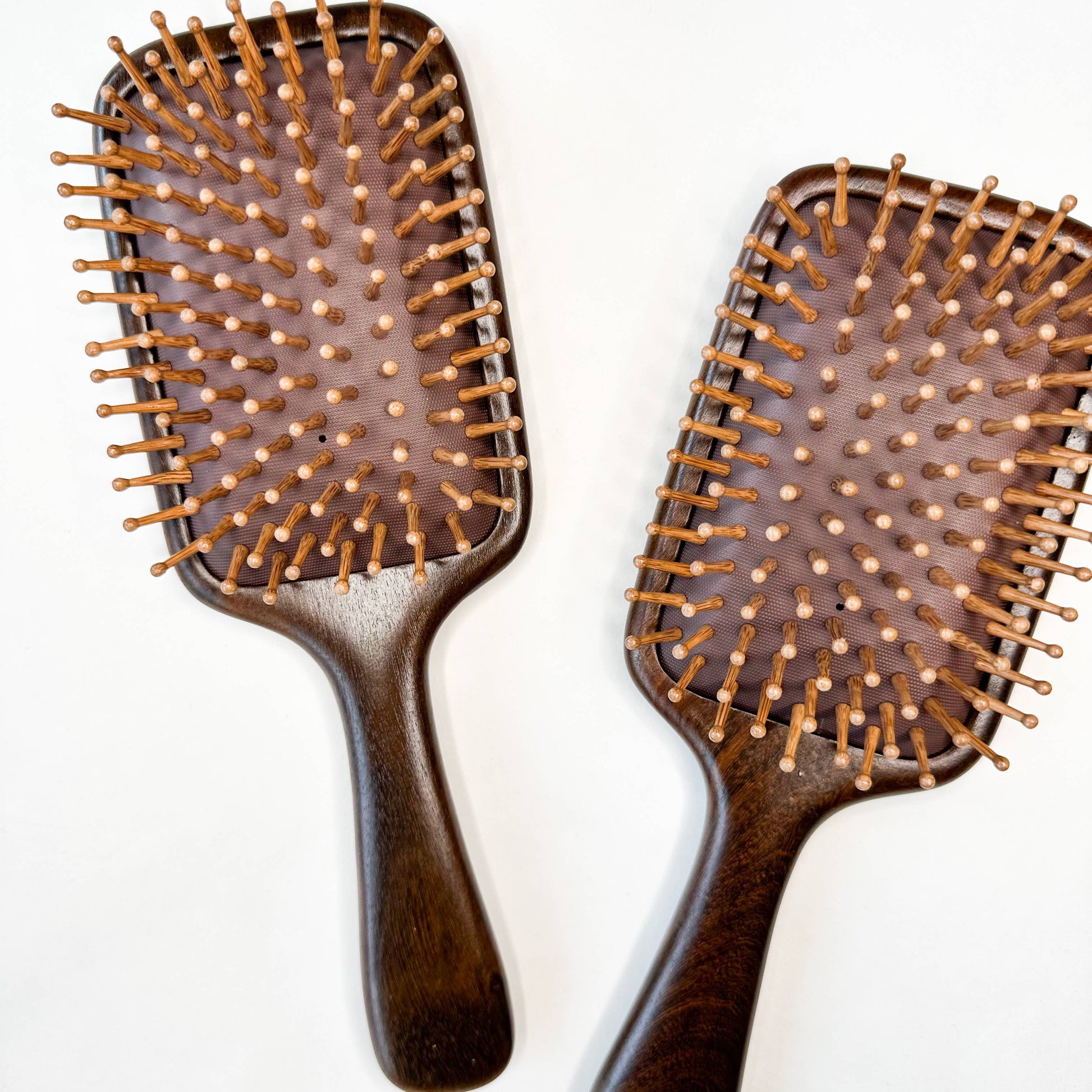 two sandalwood paddle hairbrushes