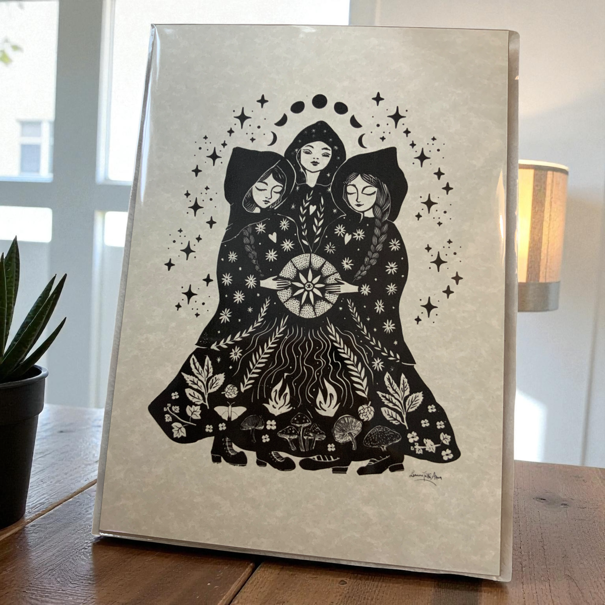 Sisters folk art print by Spirit of Lemuria shown in a frame