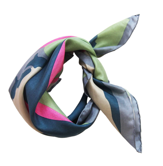Mid blue green and pink patterned scarf tied in a knot on a white background