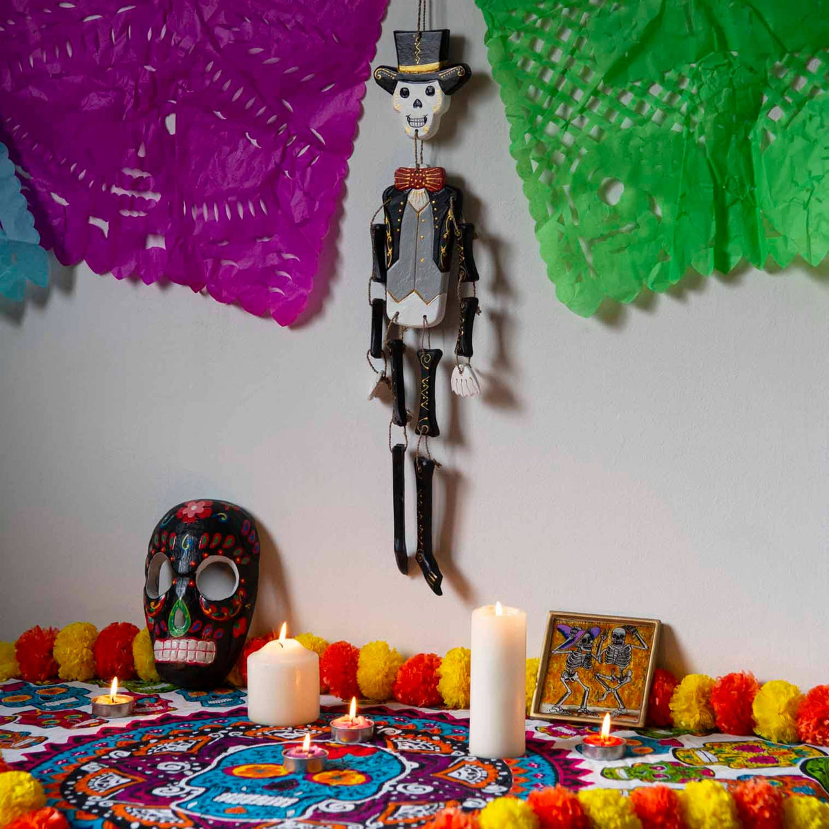 Day of the Dead calaca figure painted in bright candy-skull patterns