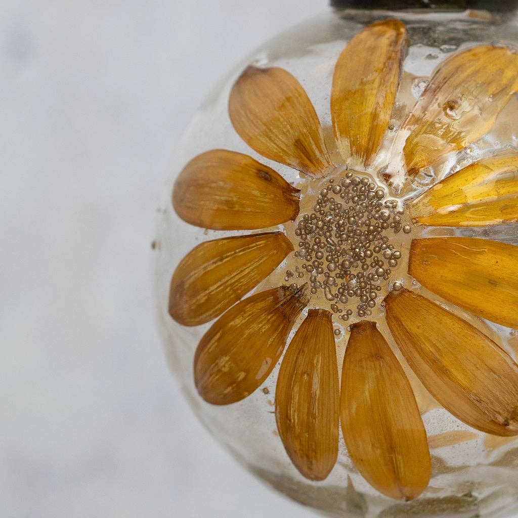 Zinnia botanical glass bauble with ochre flowers on a jute hanger