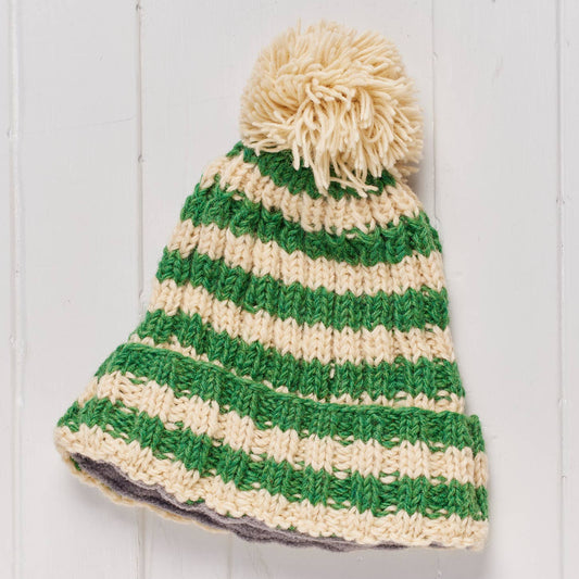 Green and beige striped beanie with a pom-pom 