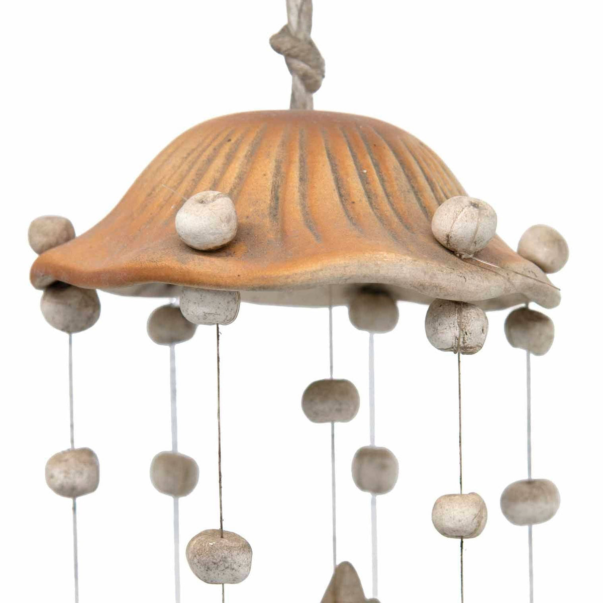 Unglazed ceramic crescent moon and star pieces on a wind chime