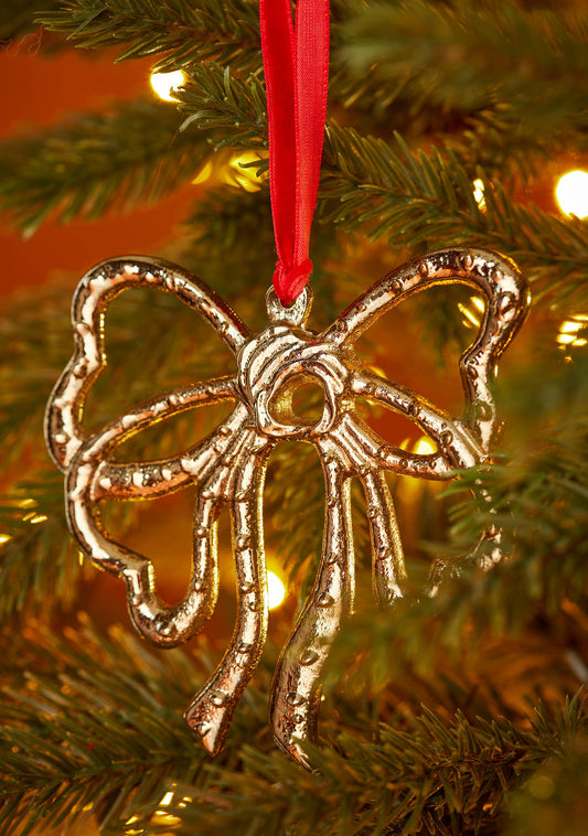 Ribbon bow Christmas decoration in gold-tone recycled aluminium on red velvet