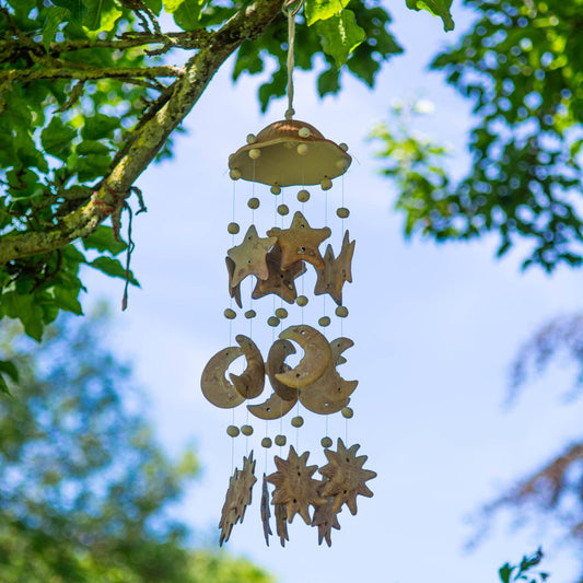 Unglazed ceramic wind chime with strings of stars, moons and suns