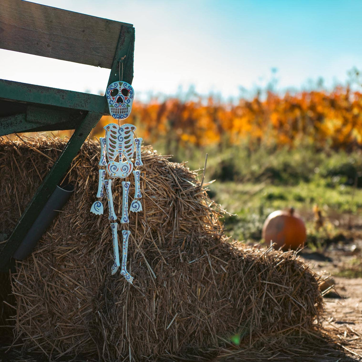 Candy skeleton painted in bright calavera patterns