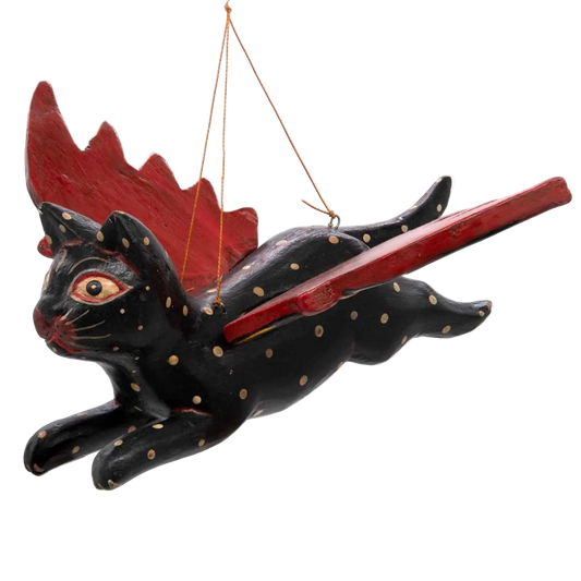 Hand-carved black flying cat with red-tipped wings, made in Bali