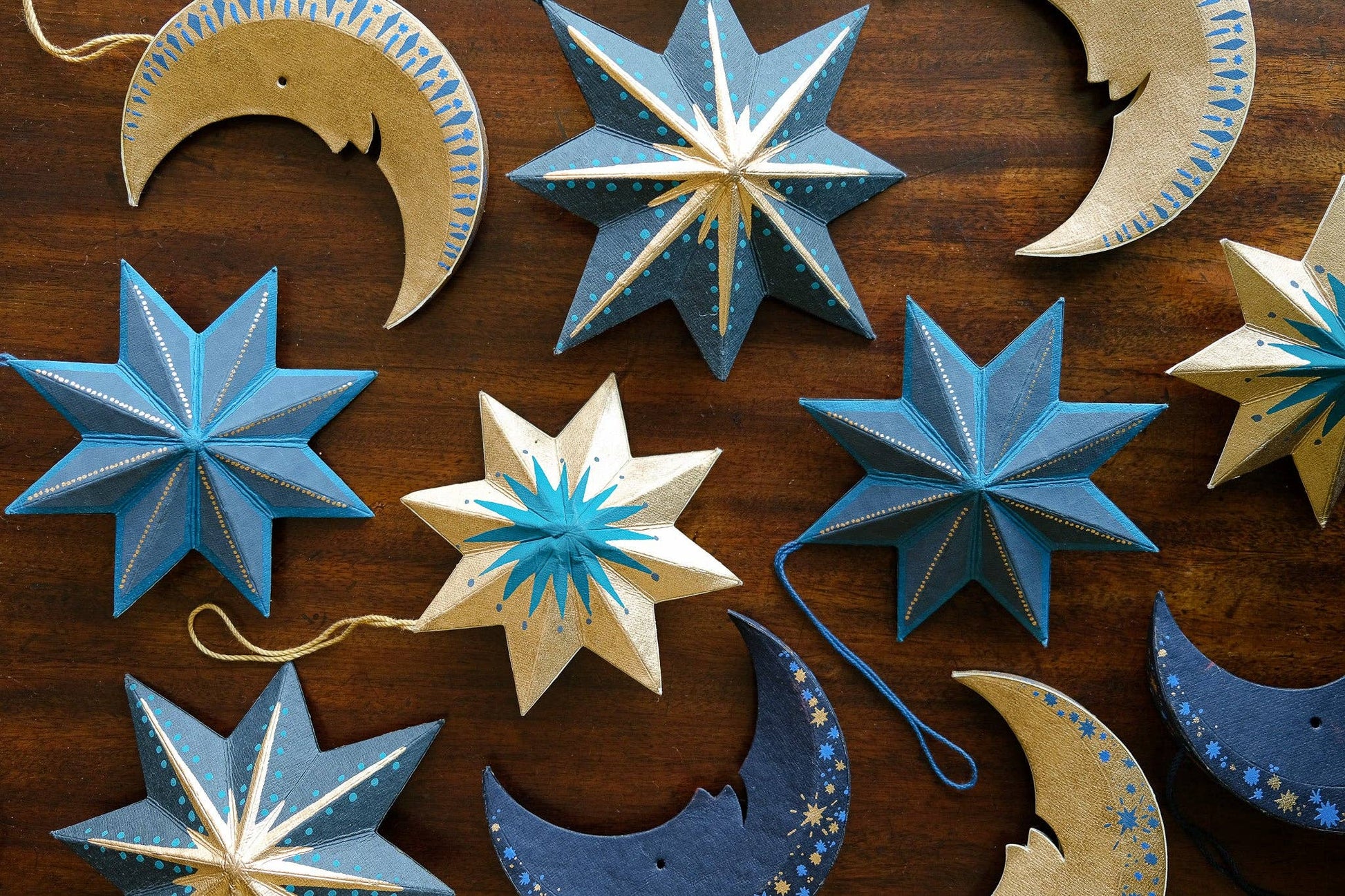 Decorative stars and moons on a wooden surface