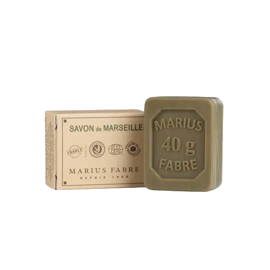 A small bar of Marseille soap next to its packaging, labeled 'MARIUS FABRE' and indicating a weight of '40g'.