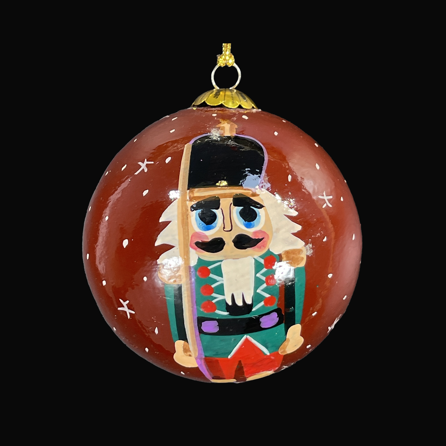Decorative Christmas ornament with a nutcracker design on a black background