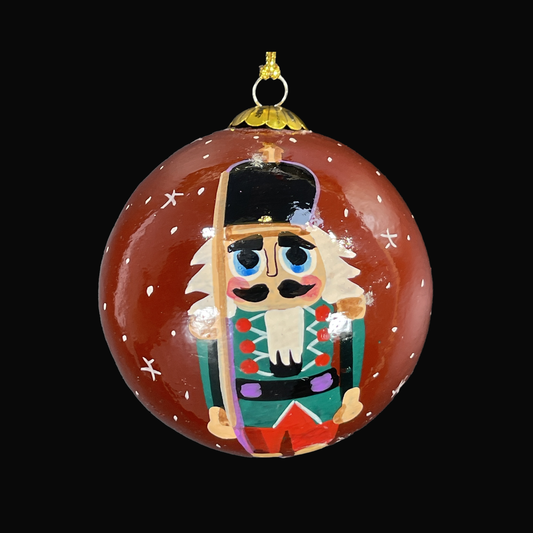 Decorative Christmas ornament with a nutcracker design on a black background